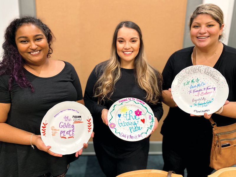 Ladies displaying plates in the classroom