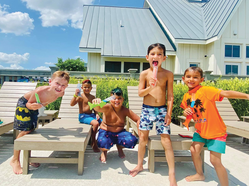 Boys with popsicles by the pool