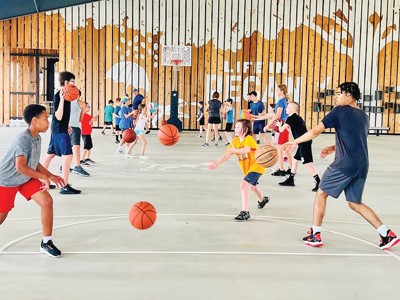 Kids playing basketball at The Arena