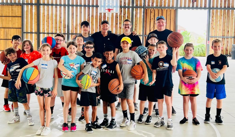 group of kids and basketball instructors inside The Arena