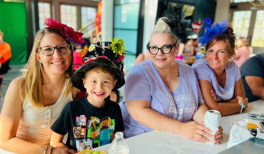3 women and boy smiling at Kentucky Derby party