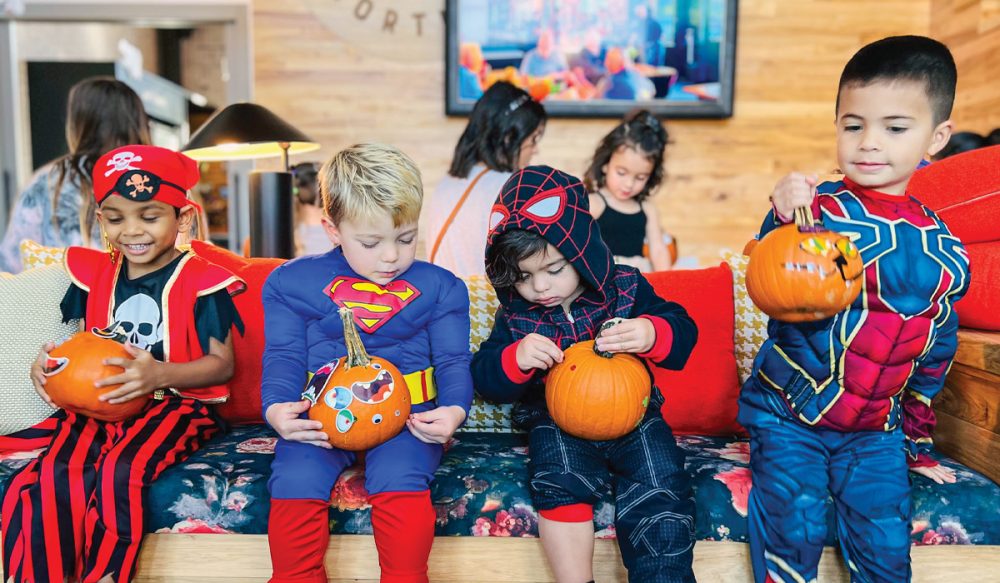 4 little boys in Halloween costumes