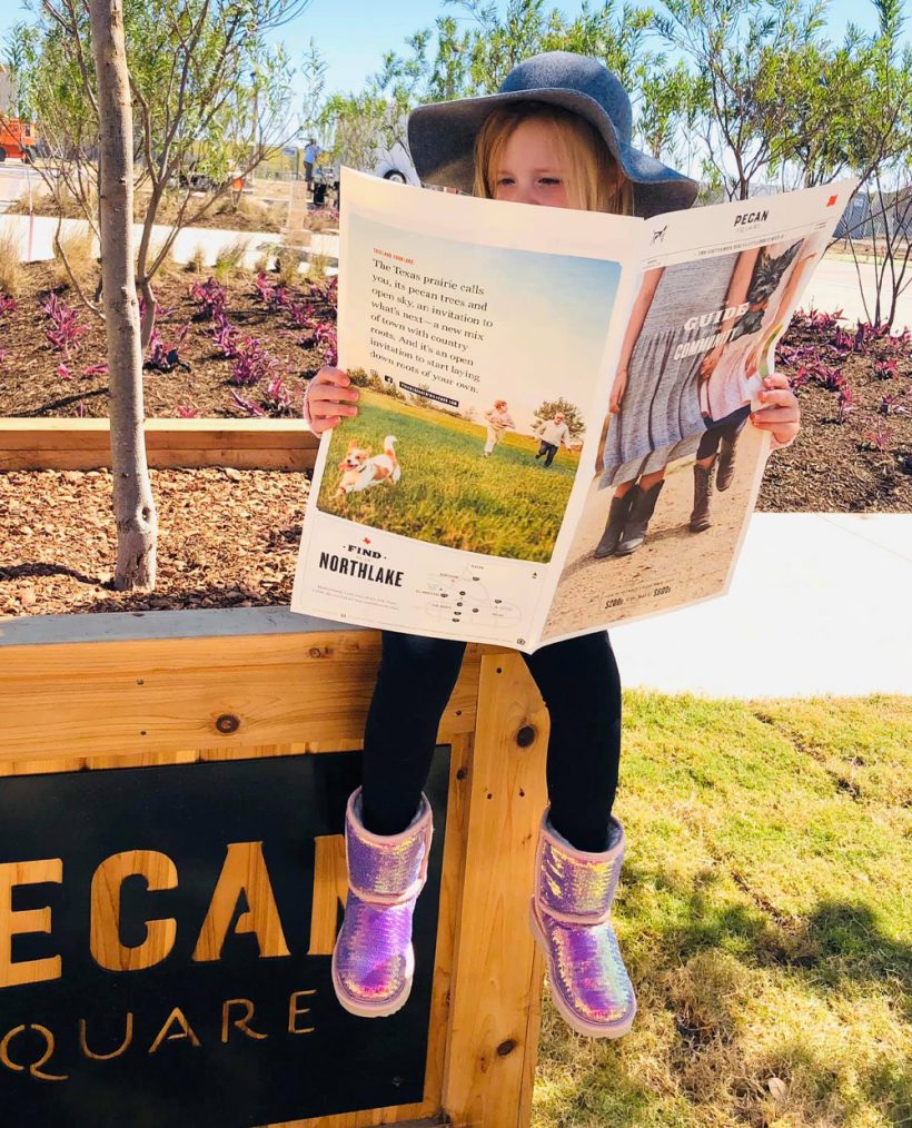 young girl reading the Pecan Square guide